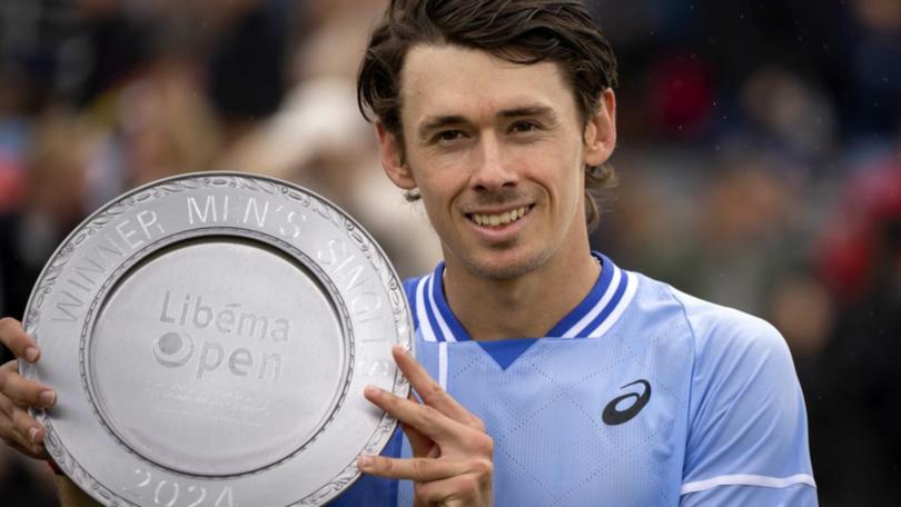 Alex de Minaur poses with the winner's trophy after his victory over Sebastian Korda in Rosmalen. (EPA PHOTO)