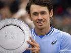 Alex de Minaur poses with the winner's trophy after his victory over Sebastian Korda in Rosmalen. (EPA PHOTO)