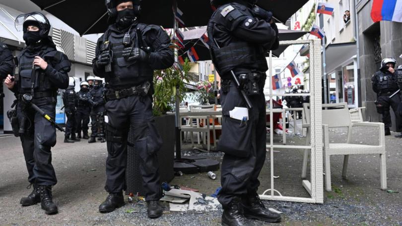 German riot police keep England and Serbia fans apart before the Euro 2024 match in Gelsenkirchen.