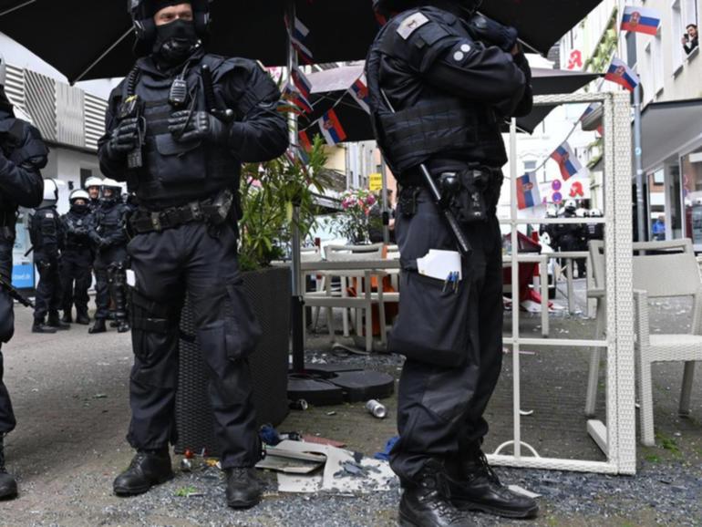 German riot police keep England and Serbia fans apart before the Euro 2024 match in Gelsenkirchen.