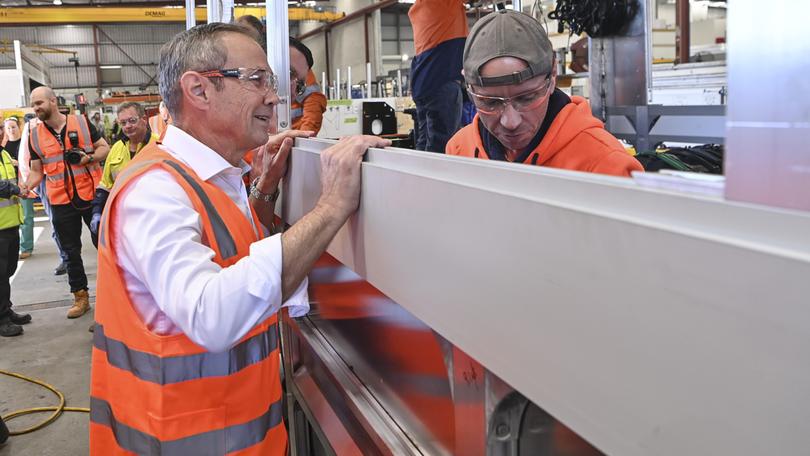 Premier Roger Cook tours the Volgren factory in Malaga where new elecrtic buses are being put together.