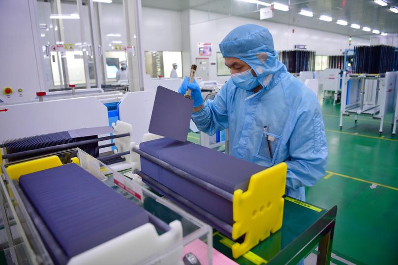 A staff member works at a monocrystalline silicon solar cell factory of LONGi Green Energy Technology Co., Ltd.