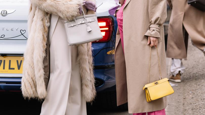 Milan, Italy - February 22, 2023: woman wearing Fendi Peekaboo and Hermes Birkin shoulder bag. Fashion blogger outfit details, street style