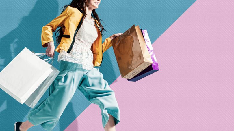 Cheerful stylish woman running to get the latest offers and carrying shopping bags, blank copy space