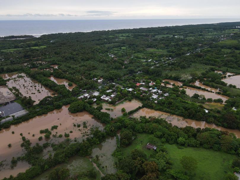 An aerial view of a flooded river swamping Metalio, El Salvador, following heavy rains in the region that let at least 11 dead.  