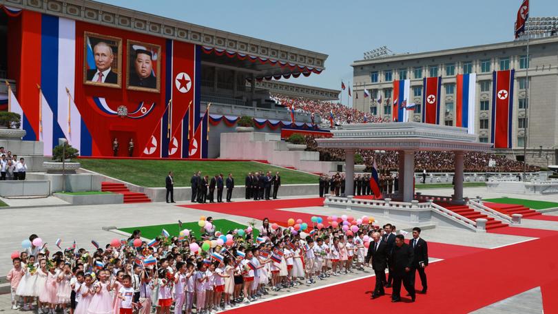 Russian President Vladimir Putin, left, and North Korean leader Kim Jong Un, second from right, attend an official welcoming ceremony during their meeting in Pyongyang.