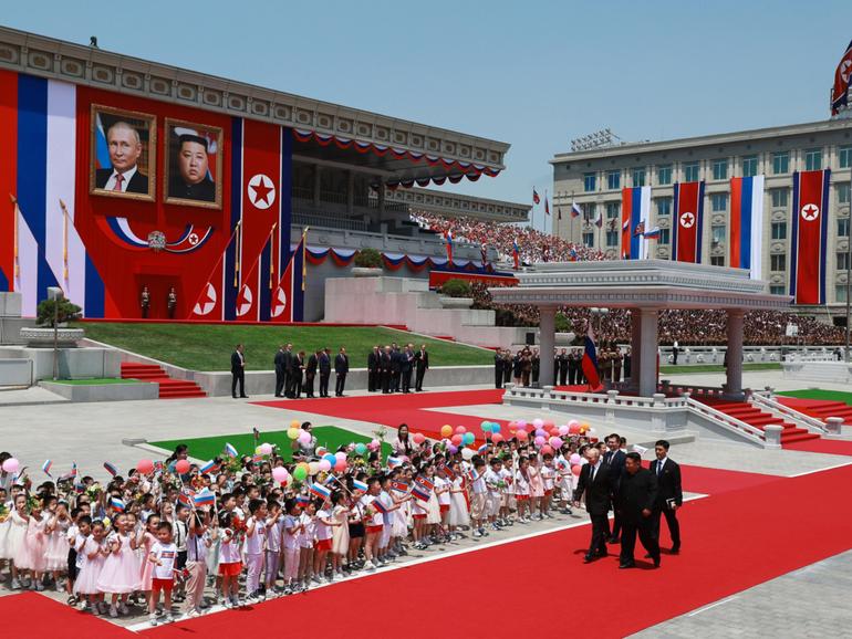 Russian President Vladimir Putin, left, and North Korean leader Kim Jong Un, second from right, attend an official welcoming ceremony during their meeting in Pyongyang.