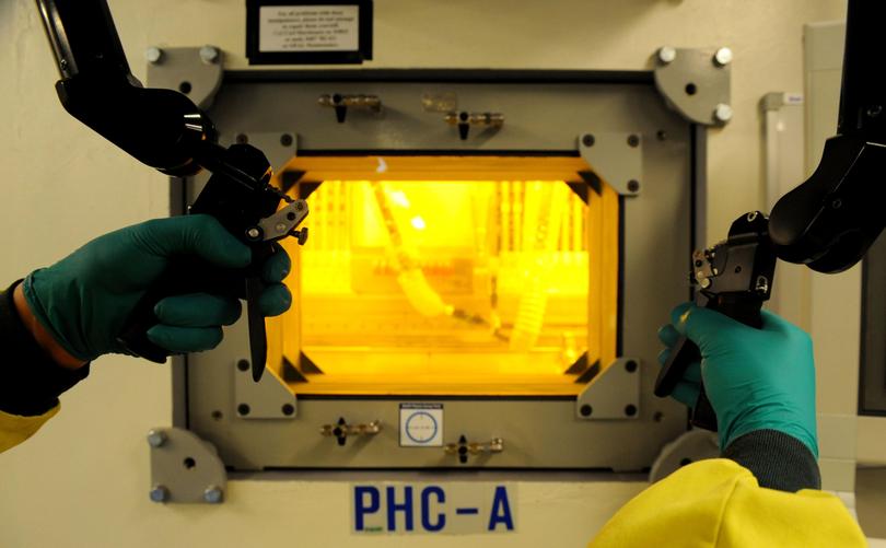 A technician uses a hot cell which shields radioactive material at the Opal nuclear research reactor at Lucas Heights in Sydney, Tuesday, Oct. 7, 2008. 