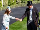 Prince William assists Carole Middleton as she gets the heel of her shoe stuck in the grass on day two of Royal Ascot 2024.