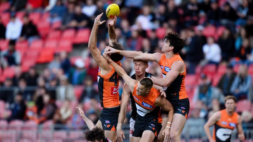 Sam Taylor (right) was injured during the Giants' win over Port Adelaide in Sydney. (Steven Markham/AAP PHOTOS)