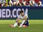 John Stones sits gloomily on the pitch after England's lacklustre 1-1 draw with Denmark at Euro 24.