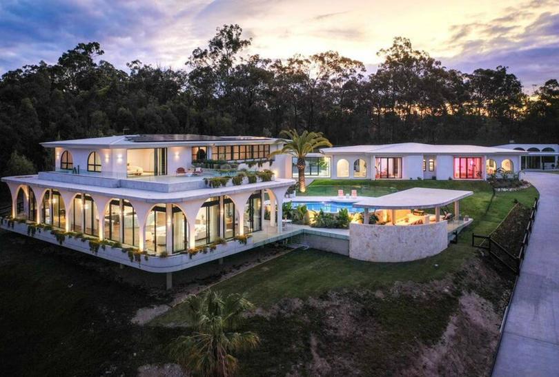 Built into a hill on a 4497-square metre block, the seven-bedroom, eight-bathroom home was designed by architect Reece Keil.