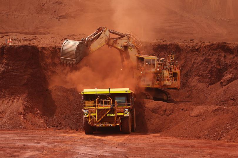 An excavator loads ore into an autonomous dump truck at Fortescue Metals Group Ltd.'s Solomon Hub mining operations in the Pilbara region, Australia, on Thursday, Oct. 27, 2016. Shares in Fortescue, the world's No. 4 iron ore exporter, have almost trebled in 2016 as iron ore recovered, and the company cut costs and repaid debt. Photographer: Brendon Thorne/Bloomberg Brendon Thorne