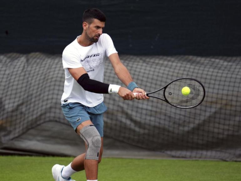 Novak Djokovic's right knee was heavily strapped during his practice session at Wimbledon. (AP PHOTO)