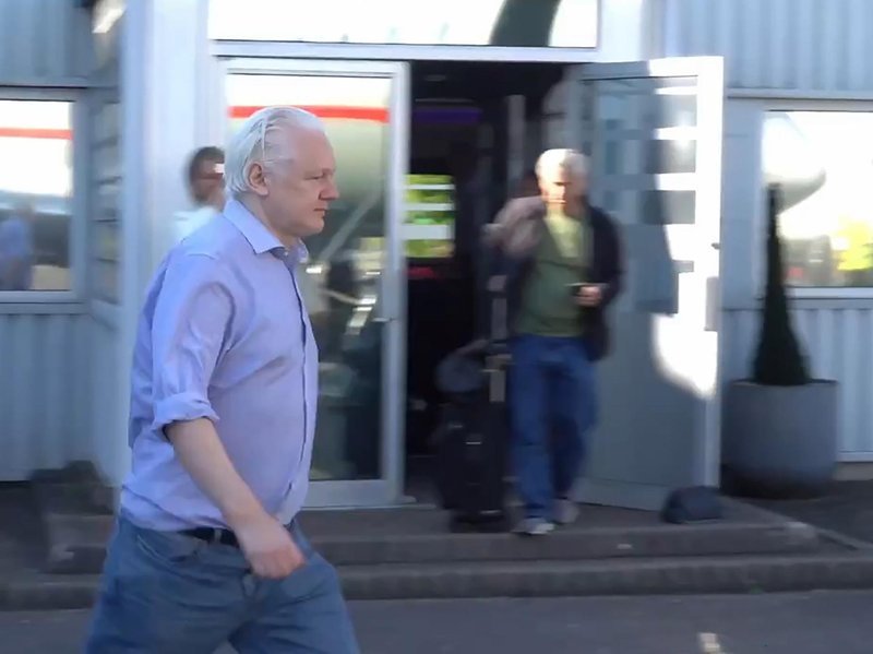 Julian Assange heading to board a plane at Stansted airport, London