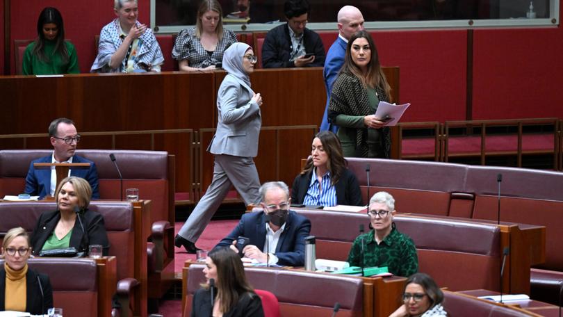 Labor Senator Fatima Payman walks with Independent Senator David Pocock as she crosses the floor.