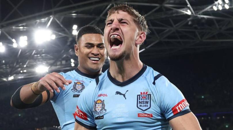 Blues State of Origin player Zac Lomax celebrates scoring a try, and probably his impressive property portfolio.