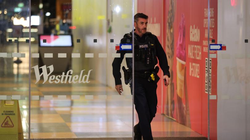 Police are seen at Westfield Marion Shopping Centre in Adelaide, Sunday, June 23, 2024. An altercation between two groups of teenagers in a food court has sent a major Adelaide shopping centre into lockdown. 