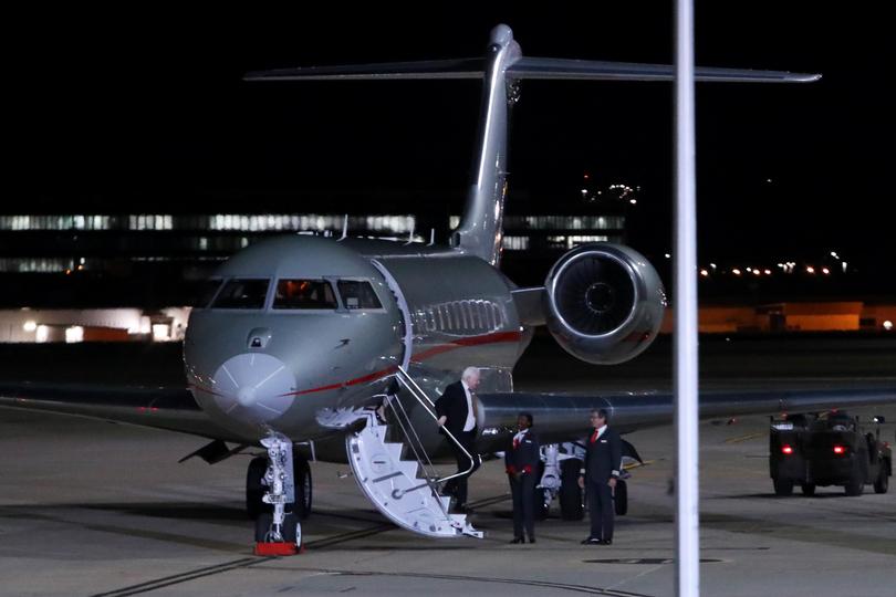 Assange disembarks from the plane.