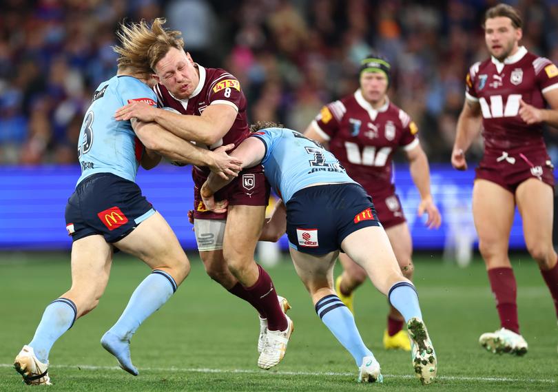 MELBOURNE, AUSTRALIA - JUNE 26: Reuben Cotter of the Maroons is tackled by Cameron Murray and Liam Martin of the Blues during game two of the men's State of Origin series between New South Wales Blues and Queensland Maroons at the Melbourne Cricket Ground on June 26, 2024 in Melbourne, Australia. (Photo by Quinn Rooney/Getty Images)