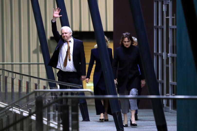 CANBERRA, AUSTRALIA - JUNE 26: WikiLeaks founder Julian Assange (L) waves as he arrives at Canberra Airport on June 26, 2024 in Canberra, Australia. Julian Assange, the WikiLeaks founder, returned to his native Australia as a free man, after attending the U.S. District Court for the Northern Mariana Islands in Saipan on Wednesday. Following his guilty plea to a felony charge under the Espionage Act, Assange was sentenced to time served and subsequently released, allowing him to walk free after years of incarceration and intense lobbying for his release from across the political spectrum. Family, supporters and politicians welcomed his release and return, with Australia's Prime Minister Anthony Albanese saying the case "had dragged on for too long." Assange's case has been a lightning rod for debates about press freedom and national security, with his supporters hailing him as a whistleblower who exposed government wrongdoing, while critics accused him of recklessly endangering lives by publishing classified information. His release marks the end of a tumultuous legal saga that spanned over a decade, involving allegations of sexual assault in Sweden, asylum in the Ecuadorian embassy in London, and a protracted battle against extradition to the United States. (Photo by Roni Bintang/Getty Images)