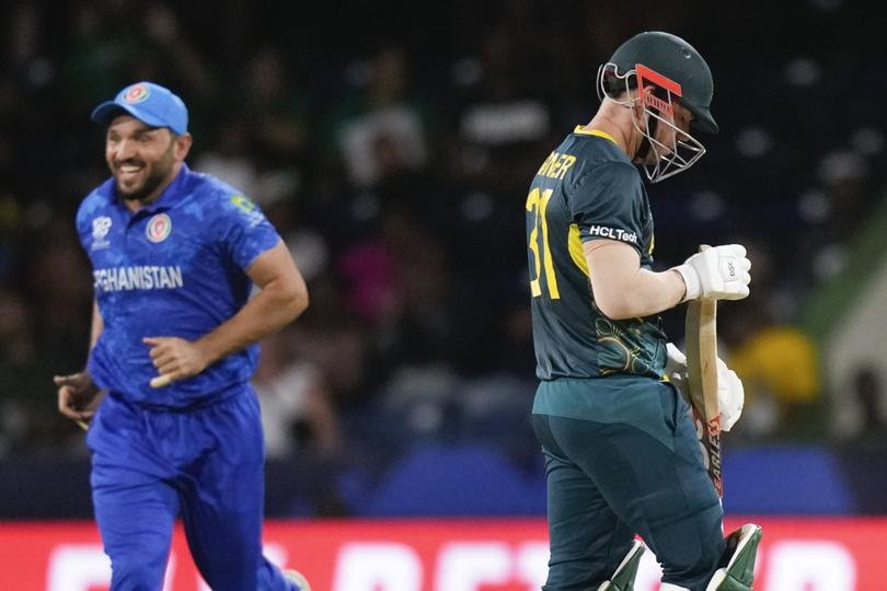 Australia's David Warner looks at his bat as he walks from the field after he was dismissed during the men's T20 World Cup cricket match between Afghanistan and Australia at Arnos Vale Ground, Kingstown, Saint Vincent and the Grenadines, Saturday, June 22, 2024. (AP Photo/Ramon Espinosa)