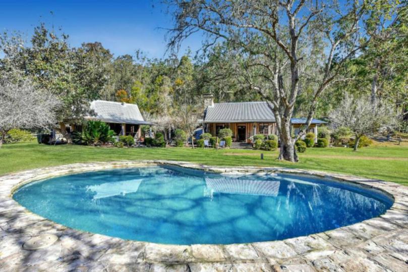 The acreage property also features an in-ground swimming pool.