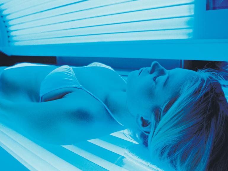 Woman using Tanning Bed