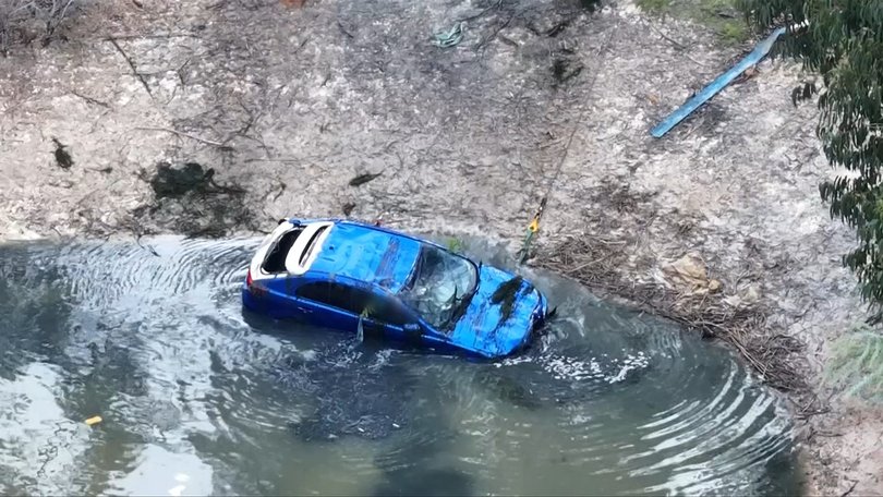 The Lancer was winched out of the dam about 11am.