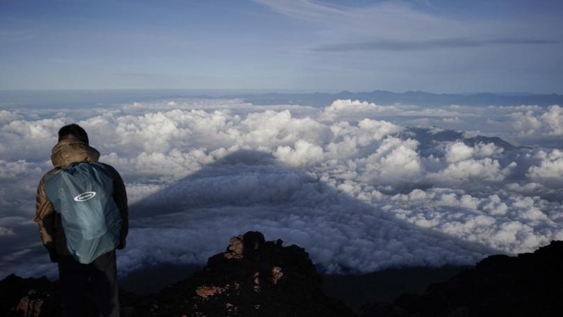 Cold temperatures and altitude sickness are risks for the thousands who scale Mount Fuji every year. (AP PHOTO)