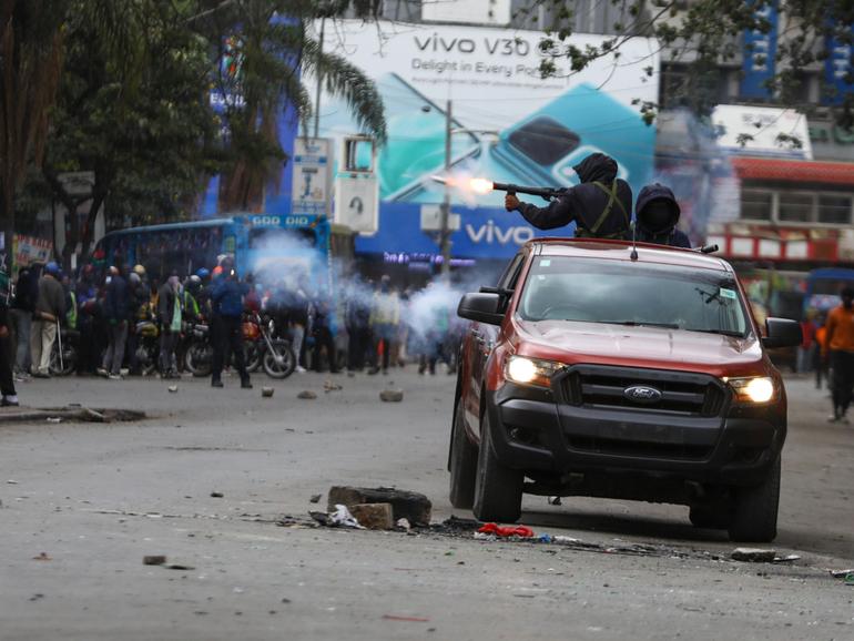 A police officer fires teargas as protests continued against the government of President William Ruto in Nairobi. 