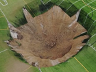 A massive sinkhole stretching 30m opened up in a park in Illinois, swallowing a light pole in the middle of recreational fields and leaving a gaping, deep hole in its wake. 