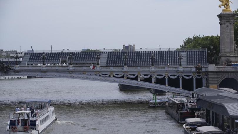 A tourist barge passes under the Alexandre III bridge on the still contaminated River Seine. (AP PHOTO)