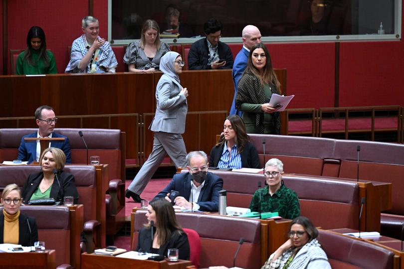 Labor Senator Fatima Payman (right) walks with Independent Senator David Pocock as she crosses the floor to a motion moved by the Australian Greens to recognize the State of Palestine during debate in the Senate chamber at Parliament House in Canberra, Tuesday, June 25, 2024. (AAP Image/Lukas Coch) NO ARCHIVING
