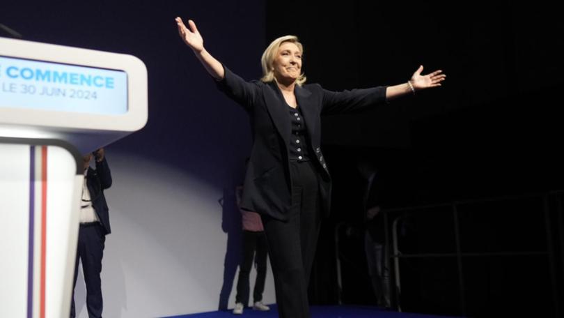 French far right leader Marine Le Pen celebrates after the release of election projections.