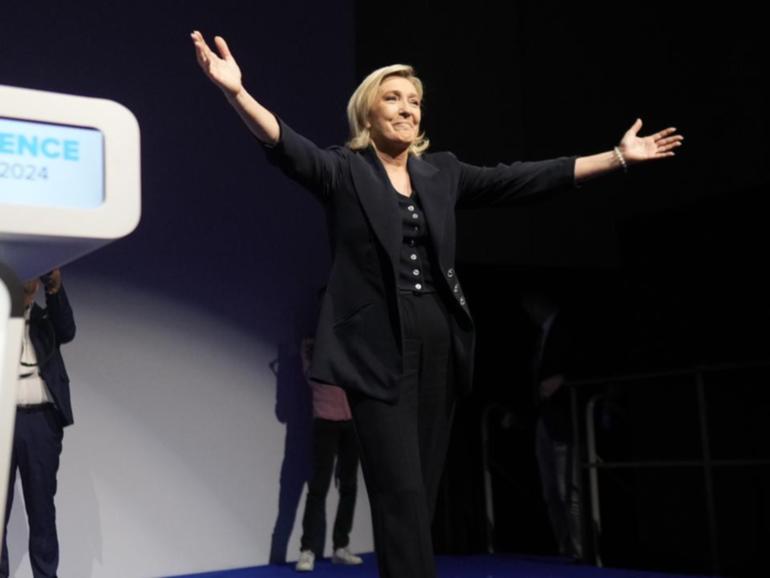 French far right leader Marine Le Pen celebrates after the release of election projections.