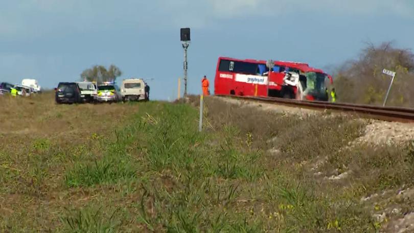 The impact forced the bus off the road and it came to a stop on the adjacent train track.