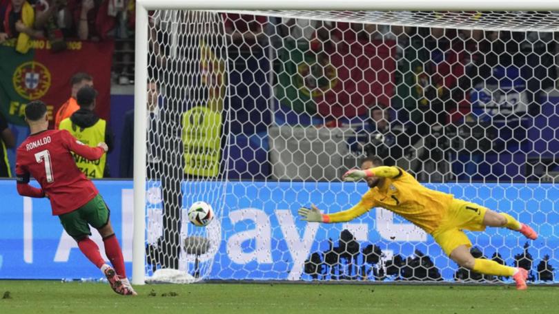 Portugal's Cristiano Ronaldo (left) scored in the penalty shootout win over Slovenia.