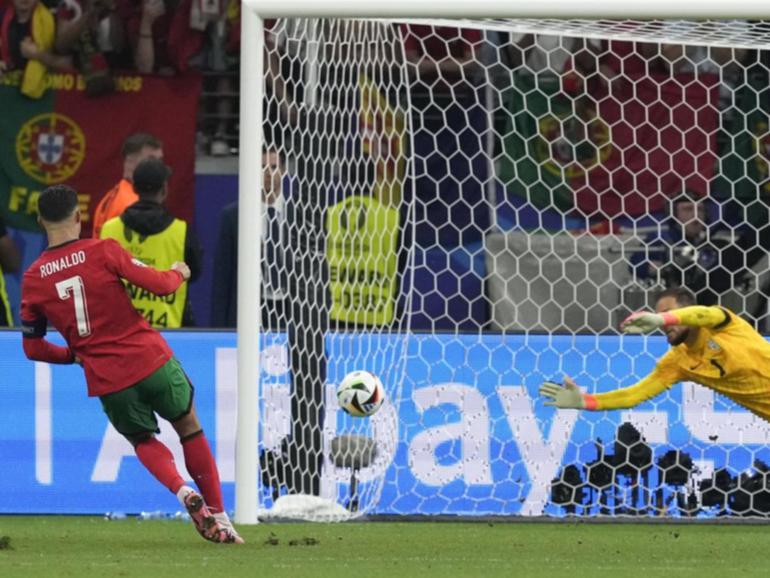 Portugal's Cristiano Ronaldo (left) scored in the penalty shootout win over Slovenia.