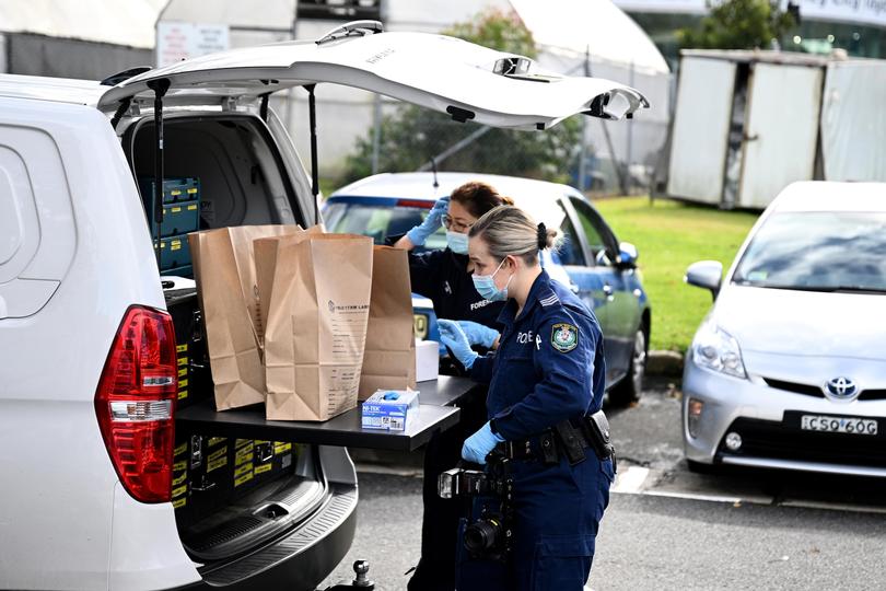 NSW Police and Forensic investigators bag items found at the scene of an alleged stabbing at University of Sydney, in Sydney, Tuesday, July 2, 2024. (AAP Image/Dan Himbrechts) NO ARCHIVING DAN HIMBRECHTS