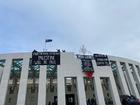 Pro-Palestine protesters unfurl banners from the roof of Parliament House in Canberra.