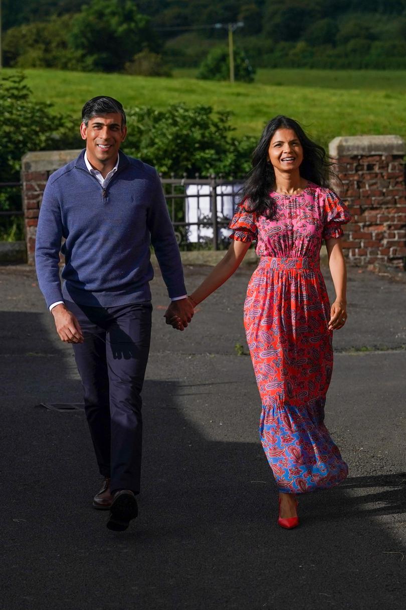 KIRBY SIGSTON, ENGLAND - JULY 4: British Prime Minister Rishi Sunak and his wife Akshata Murty arrive to cast their votes during the general election at Kirby Sigston Village Hall on July 4, 2024 in Kirby Sigston, England. Voters in 650 constituencies across the UK are electing members of Parliament to the House of Commons via the first-past-the-post system.  Rishi Sunak announced the election on May 22, 2024. The last general election that took place in July was in 1945, following the Second World War, which resulted in a landslide victory for Clement Attlee's Labour Party. (Photo by Ian Forsyth/Getty Images)