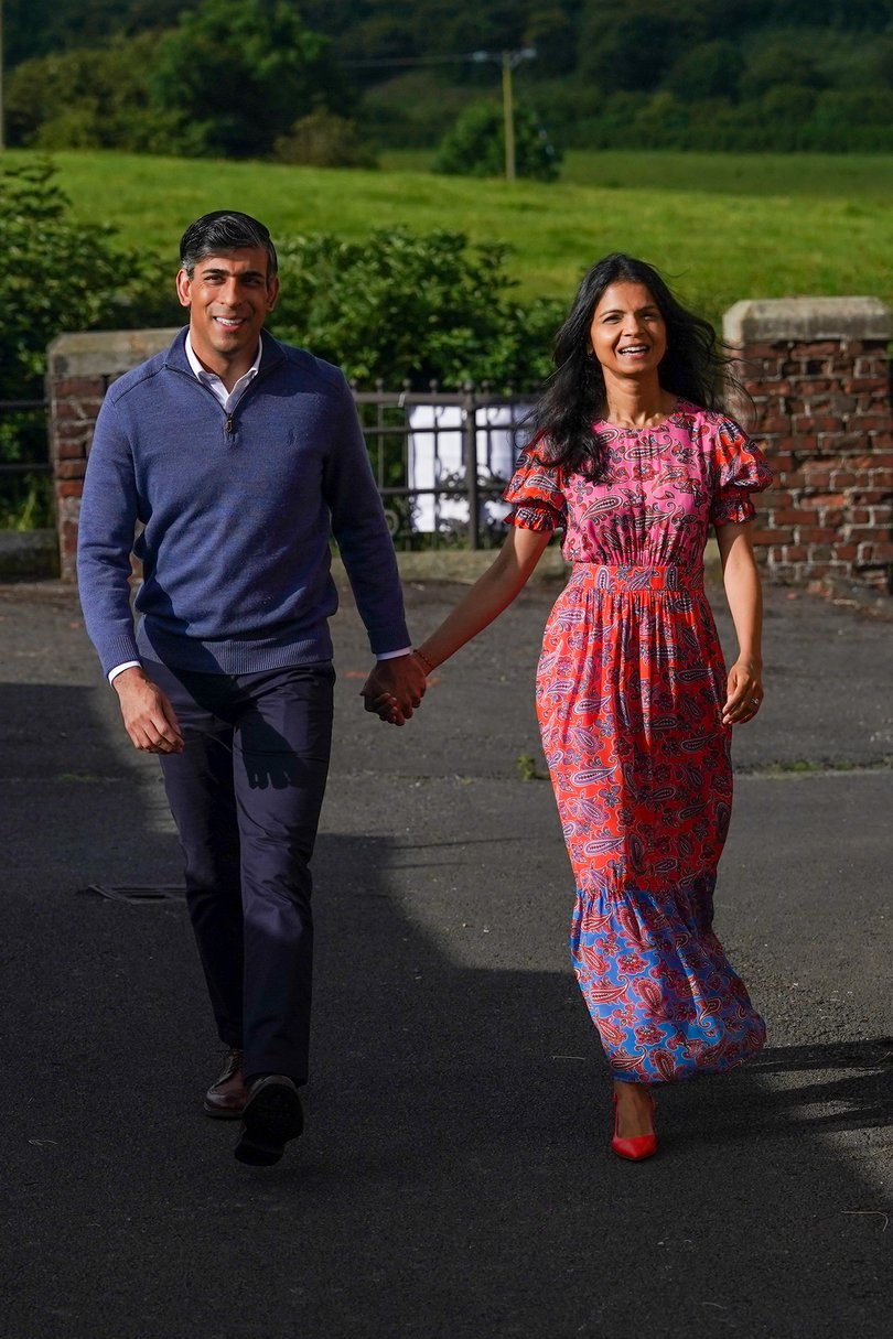 KIRBY SIGSTON, ENGLAND - JULY 4: British Prime Minister Rishi Sunak and his wife Akshata Murty arrive to cast their votes during the general election at Kirby Sigston Village Hall on July 4, 2024 in Kirby Sigston, England. Voters in 650 constituencies across the UK are electing members of Parliament to the House of Commons via the first-past-the-post system. Rishi Sunak announced the election on May 22, 2024. The last general election that took place in July was in 1945, following the Second World War, which resulted in a landslide victory for Clement Attlee's Labour Party. (Photo by Ian Forsyth/Getty Images)