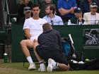 Thanasi Kokkinakis of Australia receives medical treatment before retiring injured during in his  second round match against Lucas Pouille.