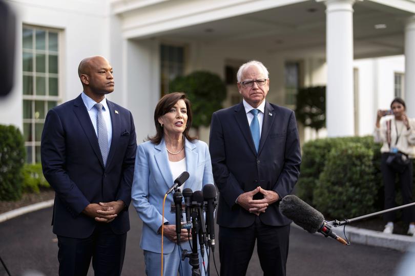 Gov. Kathy Hochul of New York is flanked by Gov. Wes Moore of maryland, left, and Gov. Tim Walz of Minnesota as she speaks to reporters after meeting with President Joe Biden at the White House.