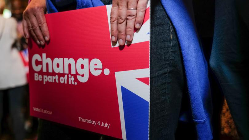 A Labour supporter waits for leader Keir Starmer.