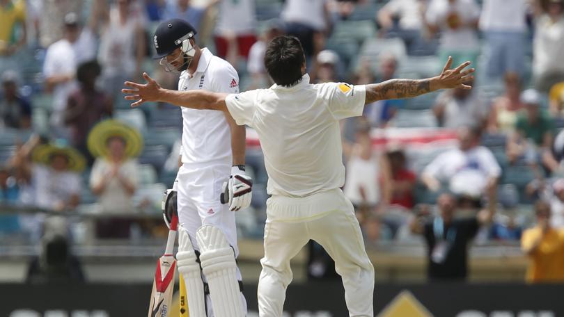 England's James Anderson, left, looks down as Australia's Mitchell Johnson celebrates Australia's victory over England in their Ashes cricket test match Tuesday, Dec. 17, 2013, in Perth, Australia. Australia won the match by 150 runs and take an unbeatable 3-0 lead in the five game series. (AP Photo/Theron Kirkman)