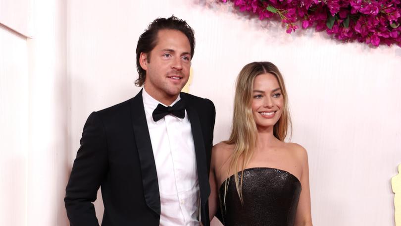 HOLLYWOOD, CALIFORNIA - MARCH 10: (L-R) Tom Ackerley and Margot Robbie attend the 96th Annual Academy Awards on March 10, 2024 in Hollywood, California. (Photo by Kevin Mazur/Getty Images)