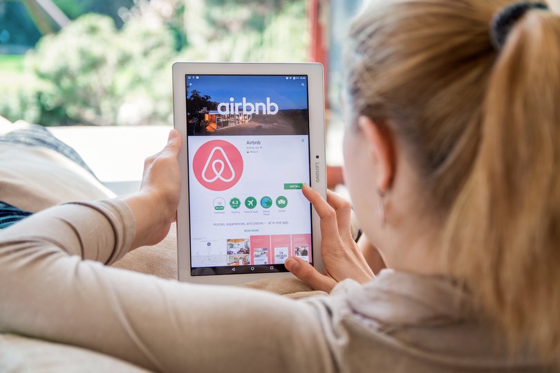 WROCLAW, POLAND- APRIL 10th, 2017: Woman is installing Airbnb application on Lenovo tablet. Airbnb is an online marketplace and hospitality service, enabling people to lease or rent short-term lodging