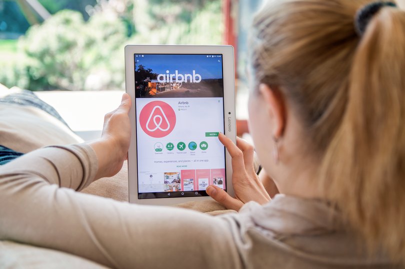 WROCLAW, POLAND- APRIL 10th, 2017:  Woman is installing Airbnb application on Lenovo tablet. Airbnb is an online marketplace and hospitality service, enabling people to lease or rent short-term lodging